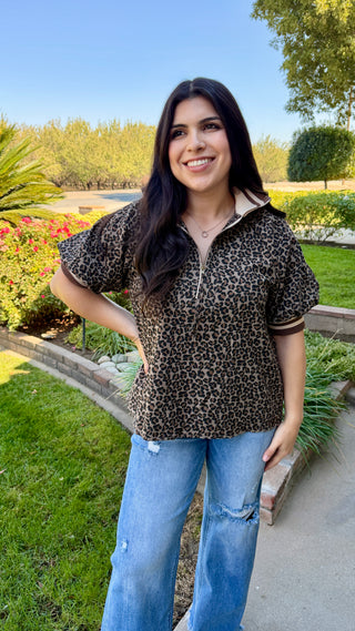 Woman wearing a leopard print top and blue jeans