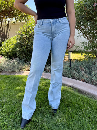 Light blue jeans with a brand label on the back pocket with rhinestones