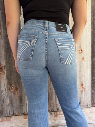 Woman wearing blue jeans on a wooden floor
