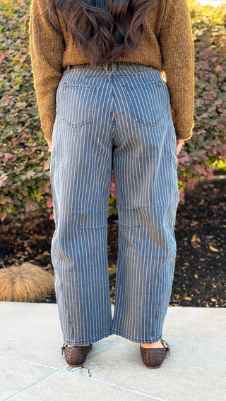 Back view of pinstripe denim barrel jeans showing the back pockets and relaxed barrel leg