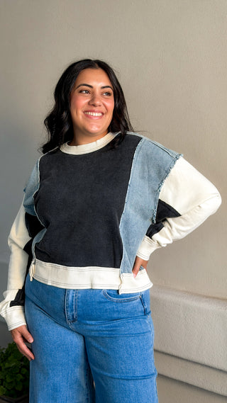 Women's black and light wash denim contrast oversized sweatshirt with soft fabric.