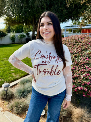 A lace long sleeve top with detailing stitched on. 