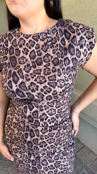 Woman wearing a leopard print sleeveless dress 