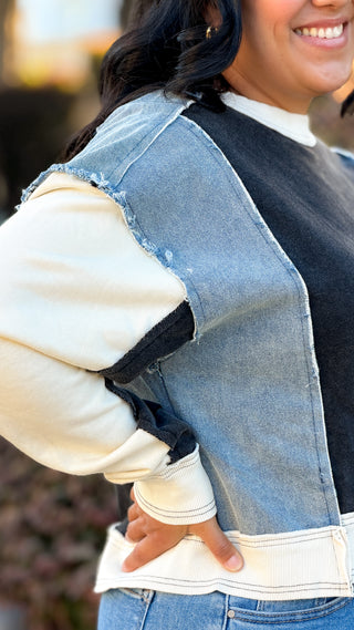Women's black and light wash denim contrast oversized sweatshirt with soft fabric.