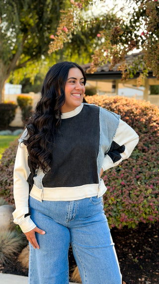 Women's black and light wash denim contrast oversized sweatshirt with soft fabric.
