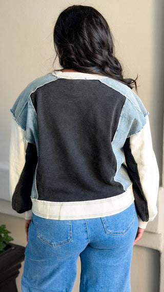 Women's black and light wash denim contrast oversized sweatshirt with soft fabric.