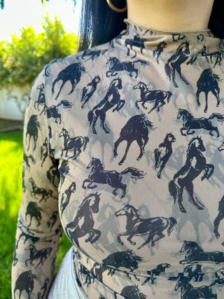 Person wearing a shirt with horse pattern outdoors