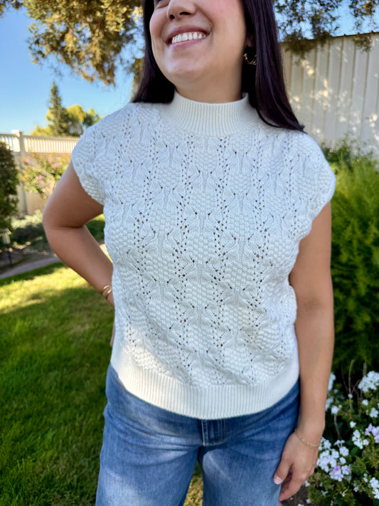 Woman wearing a light blue knitted top outdoors