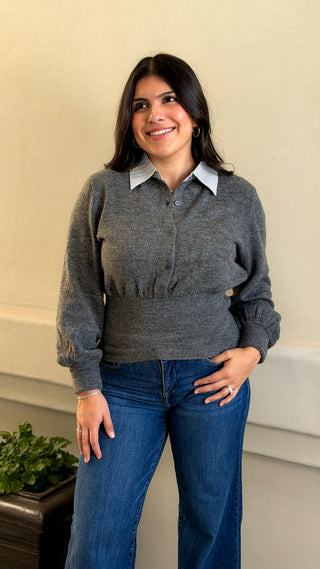 Full-length front view of a women's gray bubble sleeve sweater with white collar and straight-leg jeans