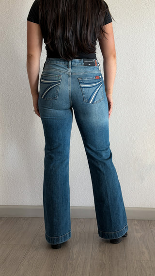 The 7 For All Mankind Tailorless Dojo women's flare jeans in Bluefern, a mid-rise medium blue wash with white contrast-stitched back pockets, short inseam