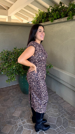 Woman wearing a leopard print sleeveless dress 