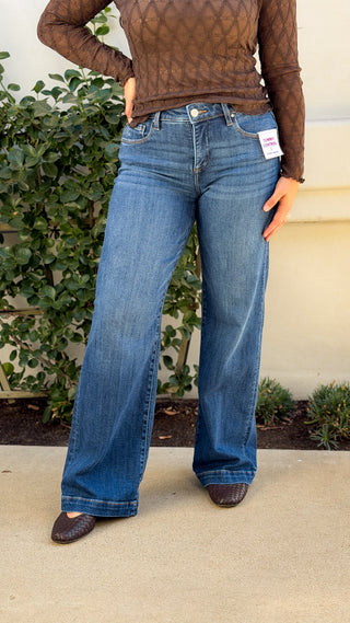 Risen tummy control mid rise wide leg jeans in medium blue wash, front view with trouser crease and deep hem