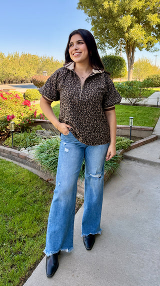 Woman wearing a leopard print top and blue jeans