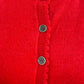 Close-up of a red garment with button details