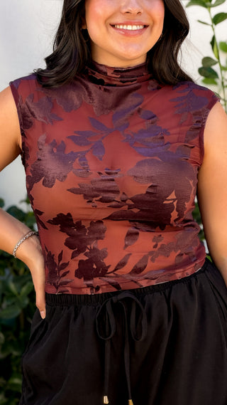 Close-up of burgundy tonal floral print sleeveless mock neck top showing the high neckline and fabric detail