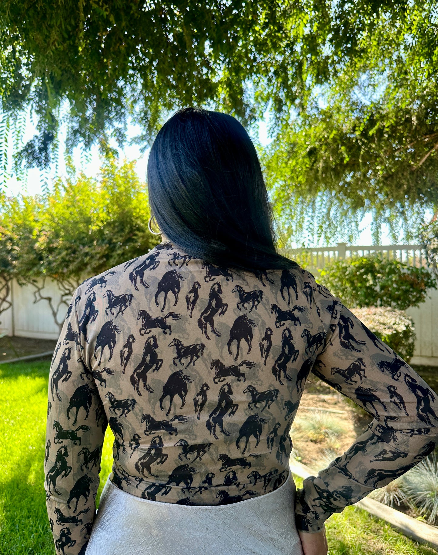 Person wearing a patterned shirt with animal designs outdoors