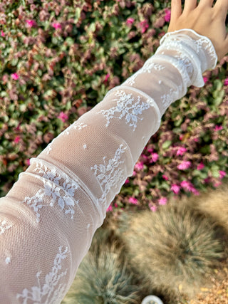 A lace long sleeve top with detailing stitched on. 