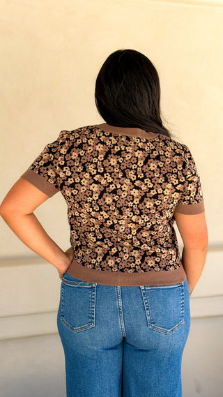 Back view of a women's brown floral knit short sleeve cardigan