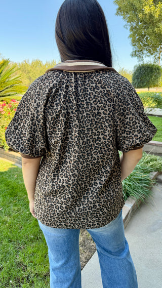 Woman wearing a leopard print top and blue jeans