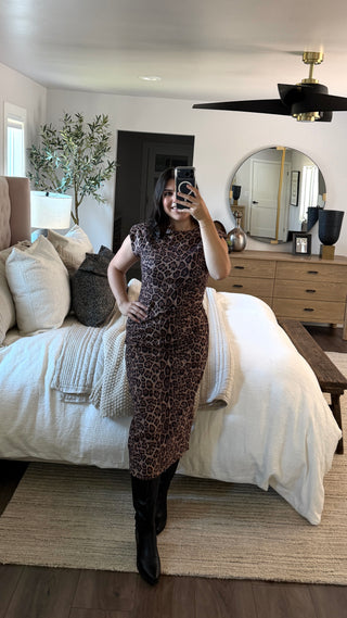 Woman wearing a leopard print sleeveless dress 