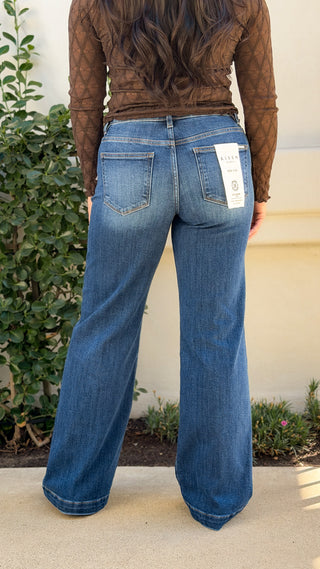 Back view of Risen mid rise wide leg trouser jeans in medium blue wash with back patch pockets