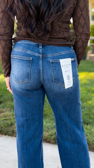 Close-up of back pockets and faded medium blue wash on Risen tummy control stretch wide leg jeans