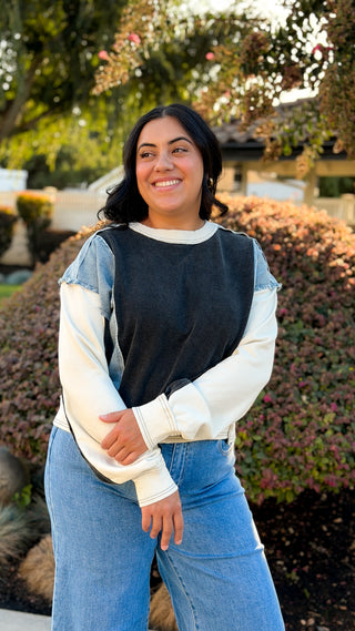 Women's black and light wash denim contrast oversized sweatshirt with soft fabric.