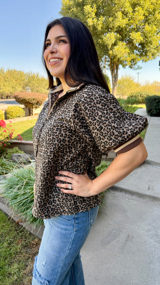 Woman wearing a leopard print top and blue jeans